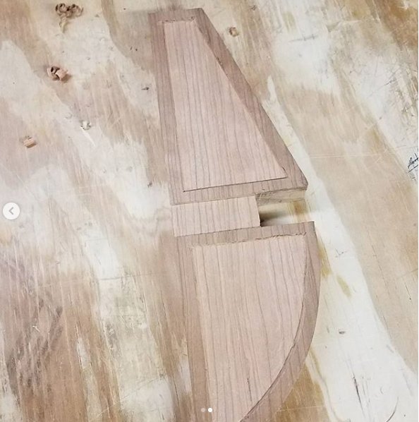 Curved work piece with relief cut by router in a curve-following base